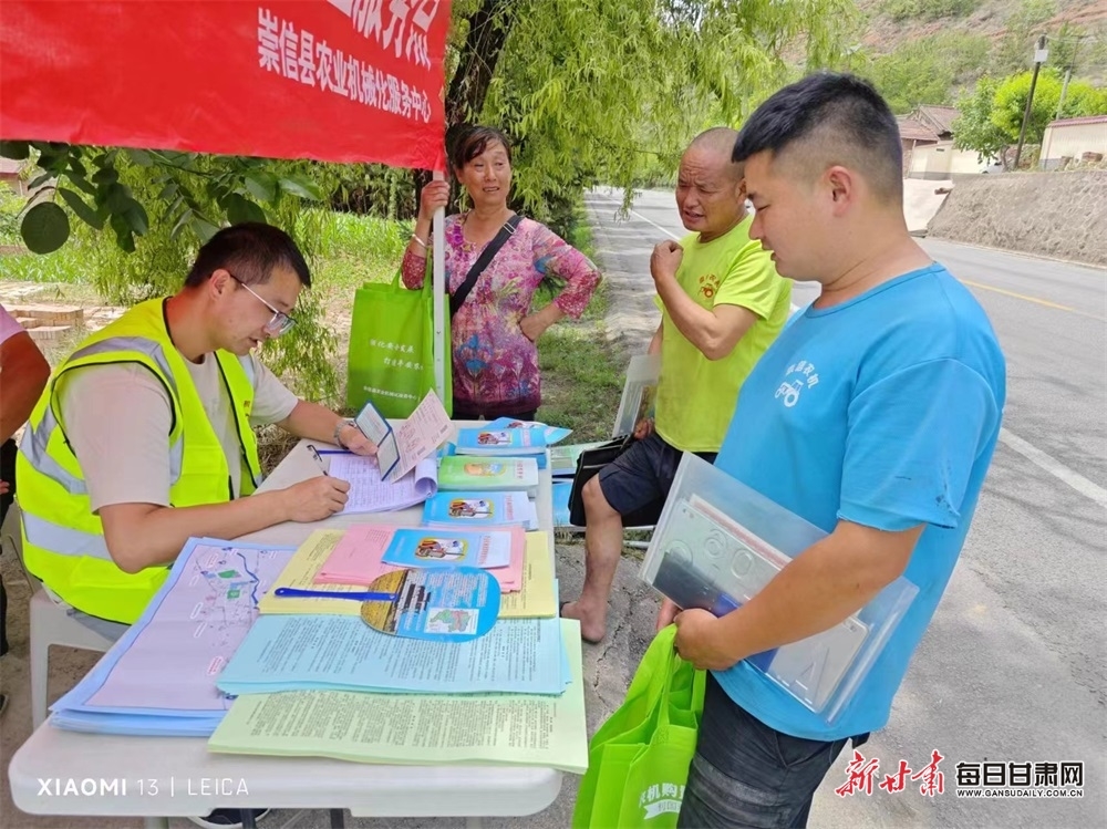 志愿者为跨区农机手进行登记服务