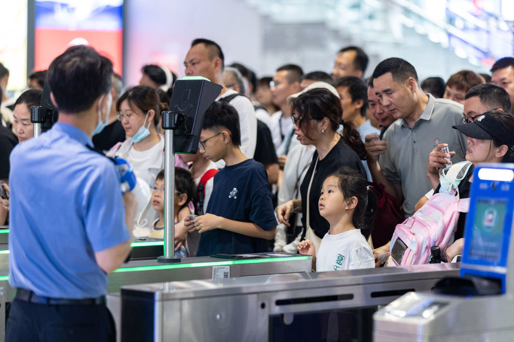 7月1日，旅客依次检票进入铁路湖州站站台。新华社发（伊凡　摄）