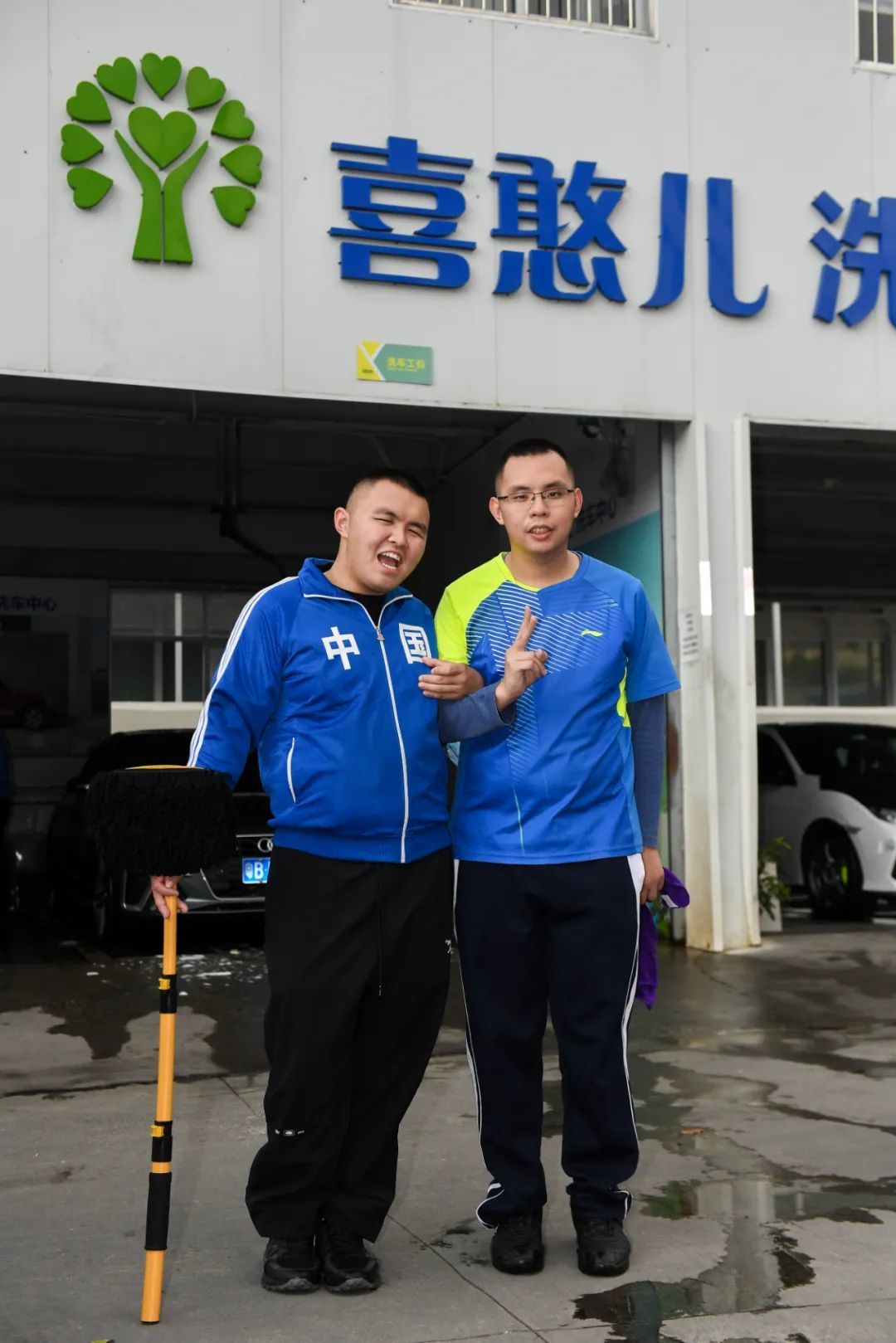这是2024年3月22日在深圳喜憨儿洗车中心拍摄的“心青年”吴华坚（左）和许继伦。新华社记者 毛思倩 摄