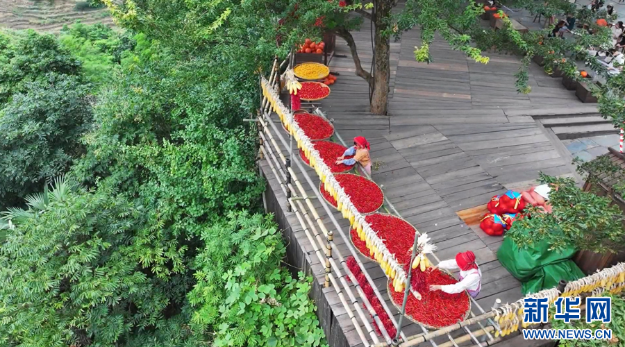 篁岭村村民正在进行红辣椒、玉米等农作物的晾晒工作。新华网发