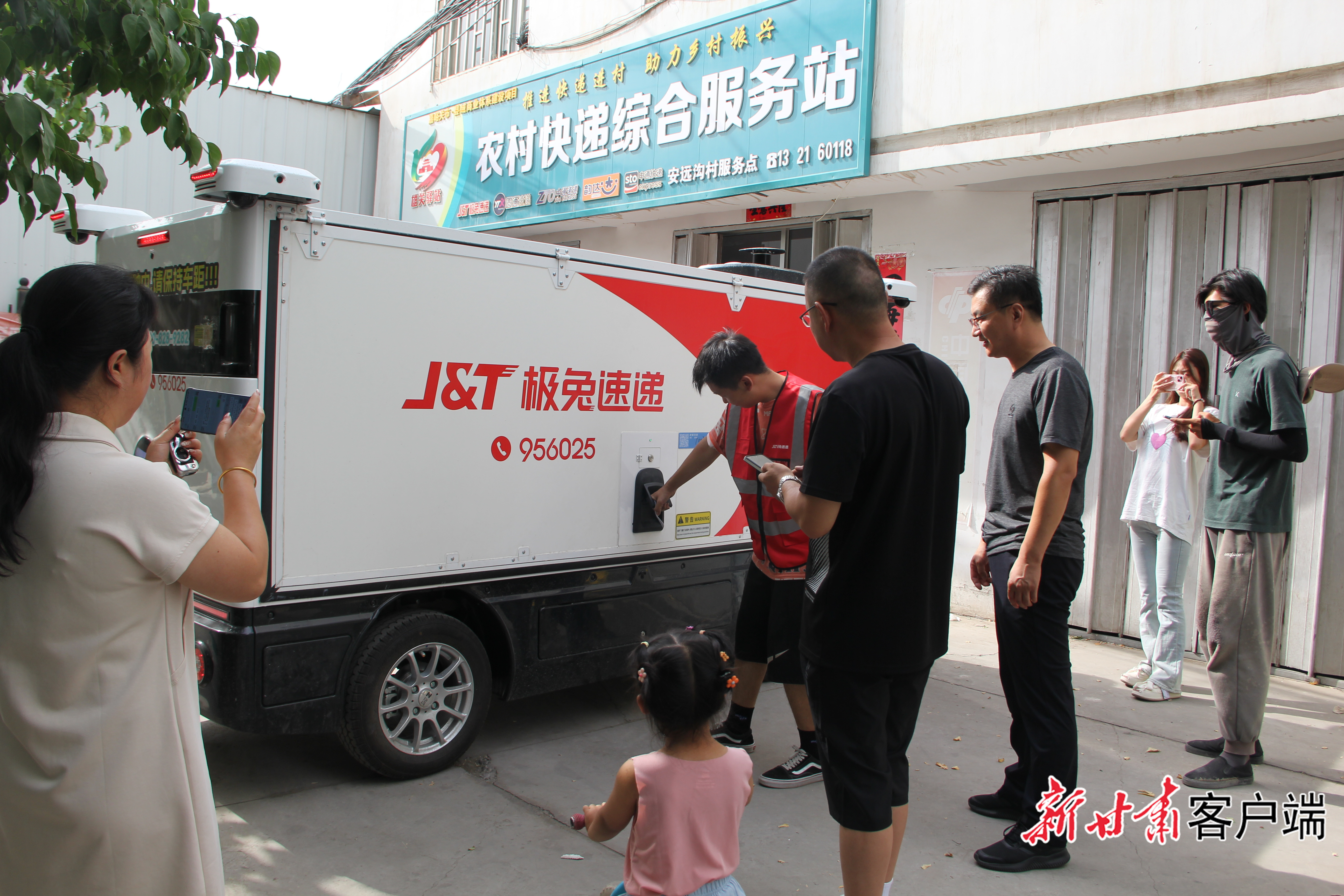 村民在智能无人快递车旁围观、拍照　新甘肃&middot;甘肃日报通讯员　赵明霞　摄