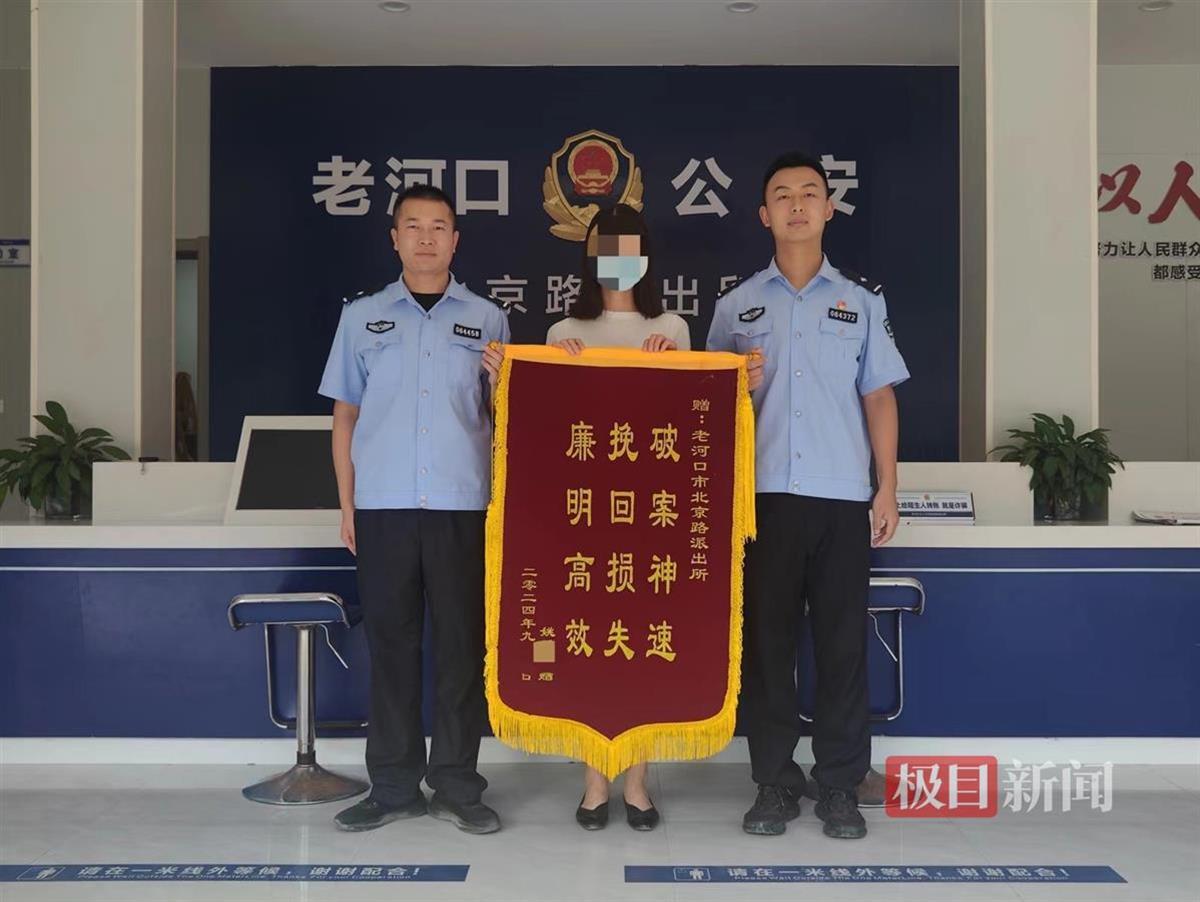 图为姚女士向民警赠送锦旗表示感谢.jpg