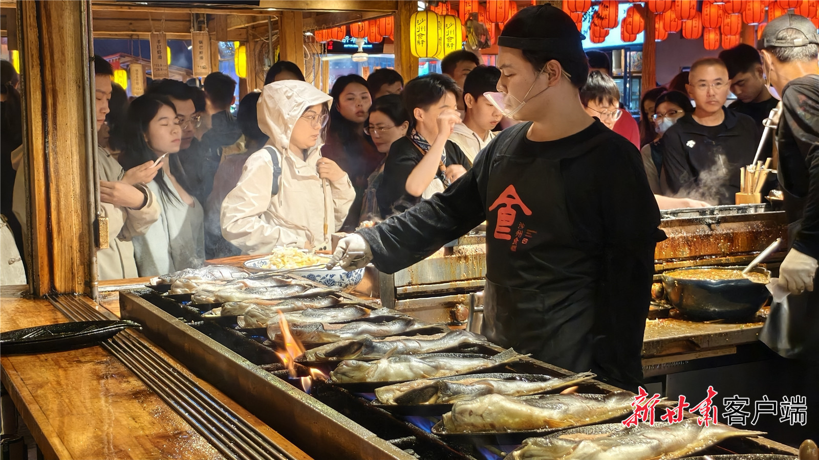 烤鱼摊前,游客排队等候。新甘肃·甘肃日报记者 冯乐凯 拍摄