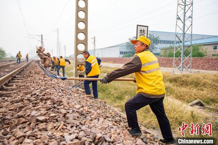 图为铁路职工对缺砟地段进行补砟作业。王宽宁磊 摄