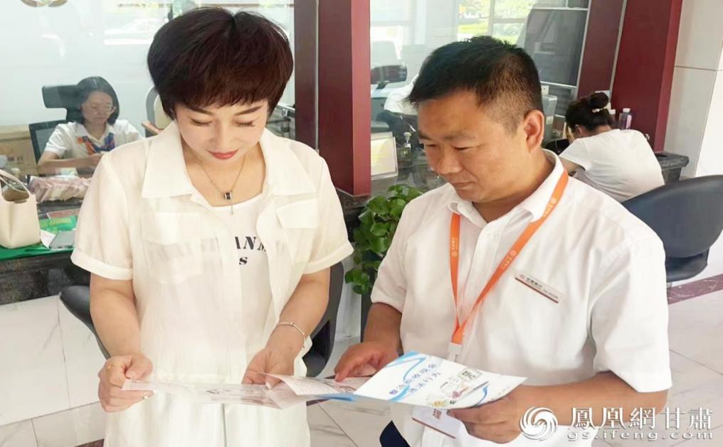 甘肃银行崇信支行工作人员（前右）为客户讲解普惠金融政策　甘肃银行崇信支行供图