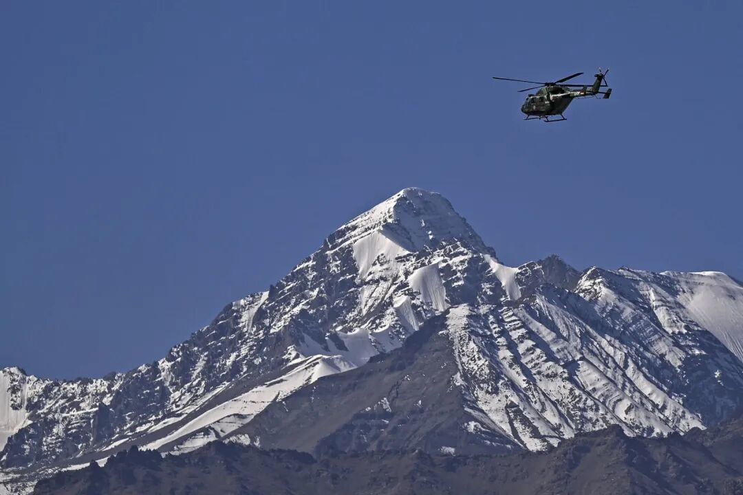 An Indian military helicopter flies over the skies of Leh in Ladakh during a curfew.