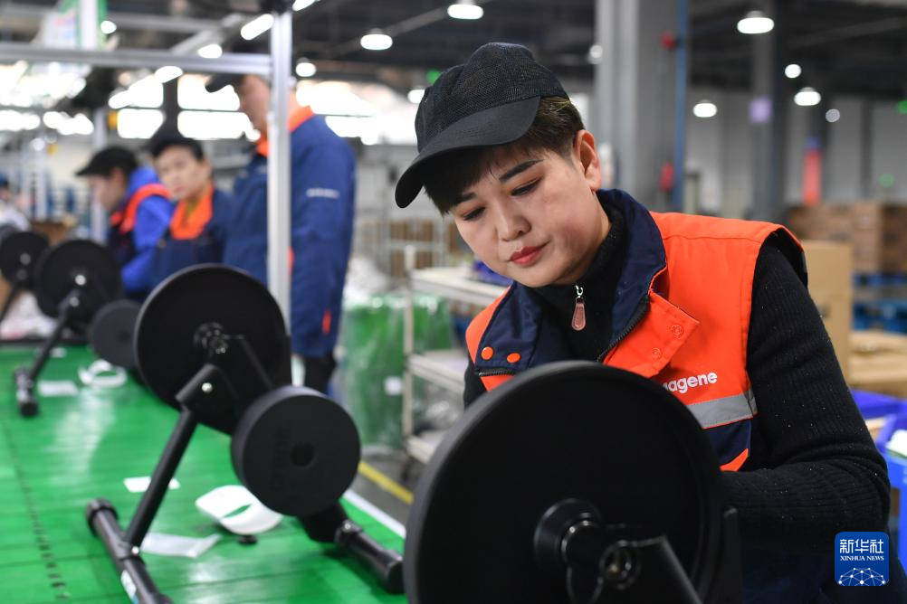 1月3日，在山东省青岛市城阳区夏庄街道青岛迈金智能科技股份有限公司生产车间，工人在调整智能骑行台。新华社发（王海滨摄）