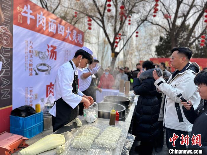图为活动现场的牛肉面制作环节吸引观众观看 杨娜 摄