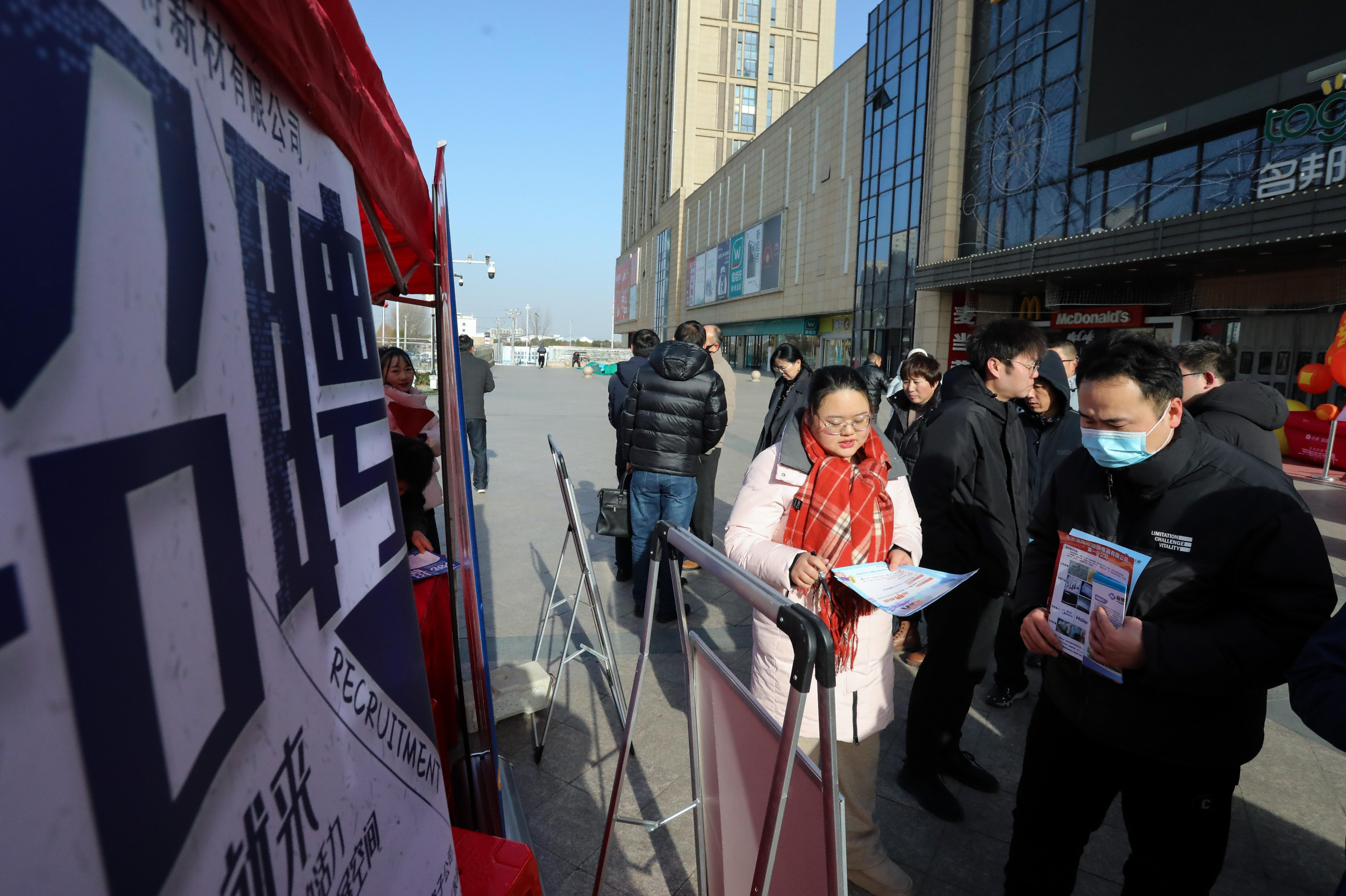 (图为:2025年2月7日,在安徽省合肥市肥西县上派镇名邦广场,用人单位工作人员向求职者介绍招聘岗位信息。)