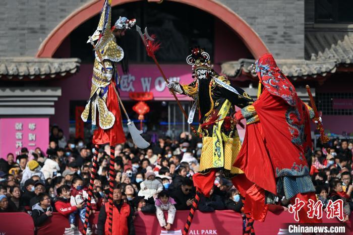 2月12日,甘肃兰州老街,高跷表演吸引民众驻足观赏。当日是农历正月十五元宵节,兰州老街举行丰富多彩的社火展演,迎接元宵节的到来。中新社记者 九美旦增 摄