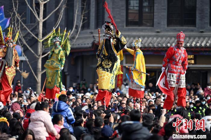2月12日,甘肃兰州老街,高跷表演吸引民众驻足观赏。当日是农历正月十五元宵节,兰州老街举行丰富多彩的社火展演,迎接元宵节的到来。中新社记者 九美旦增 摄