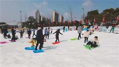 市民在人工造雪的滑雪场游玩