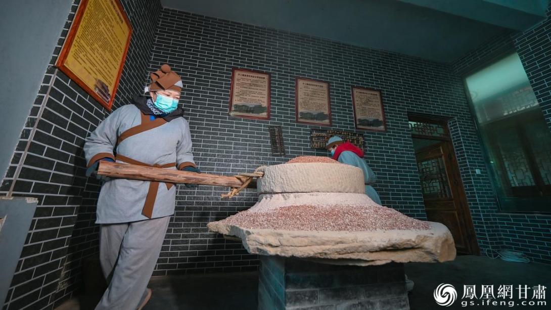 工人正在粉碎高粱、大麦等谷物原料,这是酿醋的第一步。