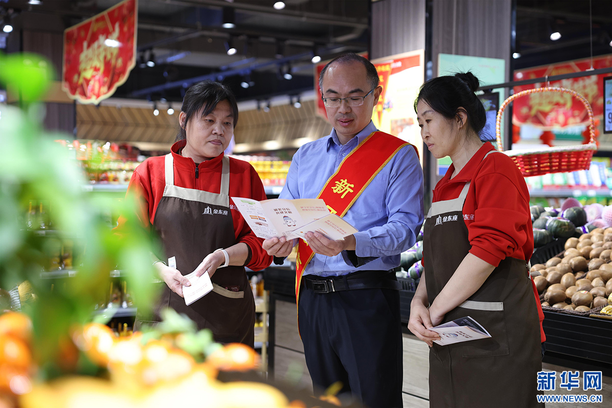 新河县行政审批局工作人员介绍信用宣传手册。新华网发 李世强 摄