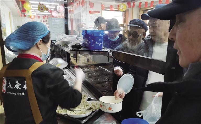 老人们有序排队打饭