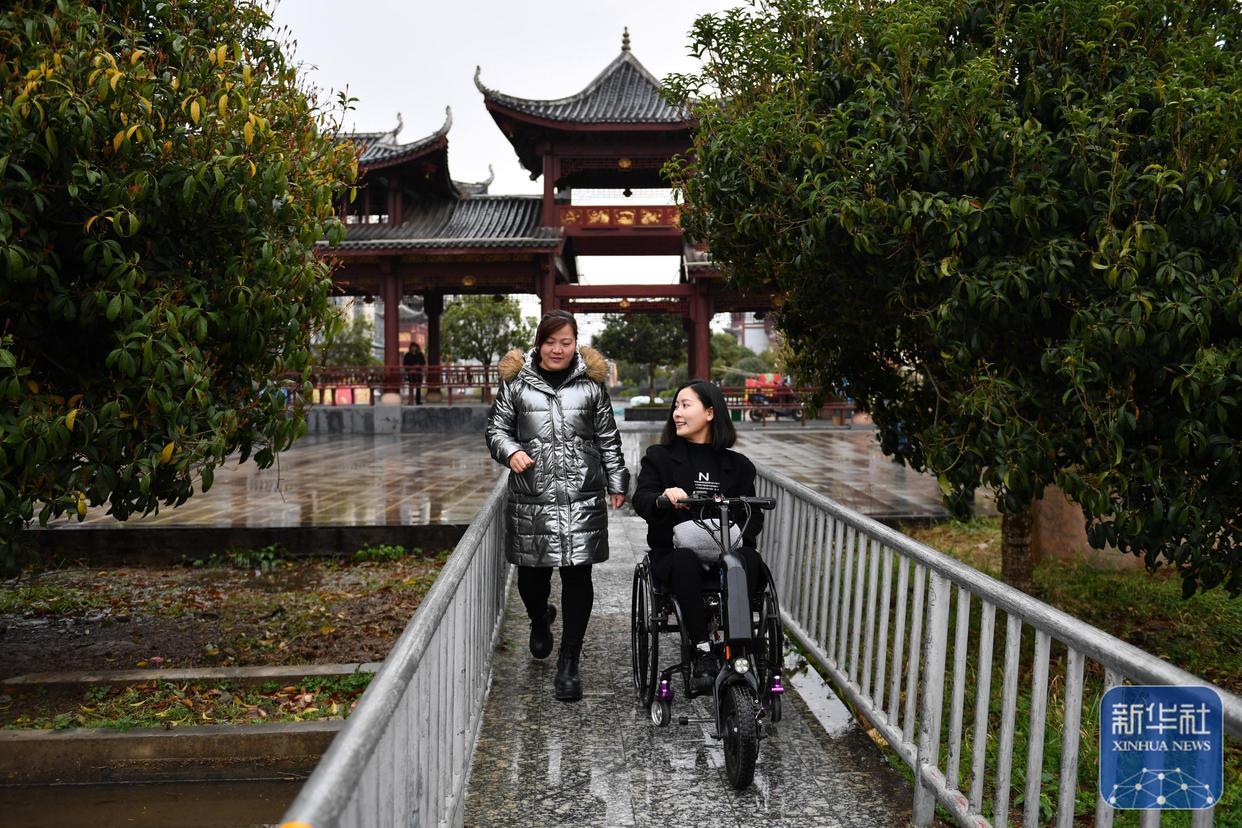 3月5日,在湖南省邵阳市城步苗族自治县,杨淑亭(右)在生产车间外与助理交流。