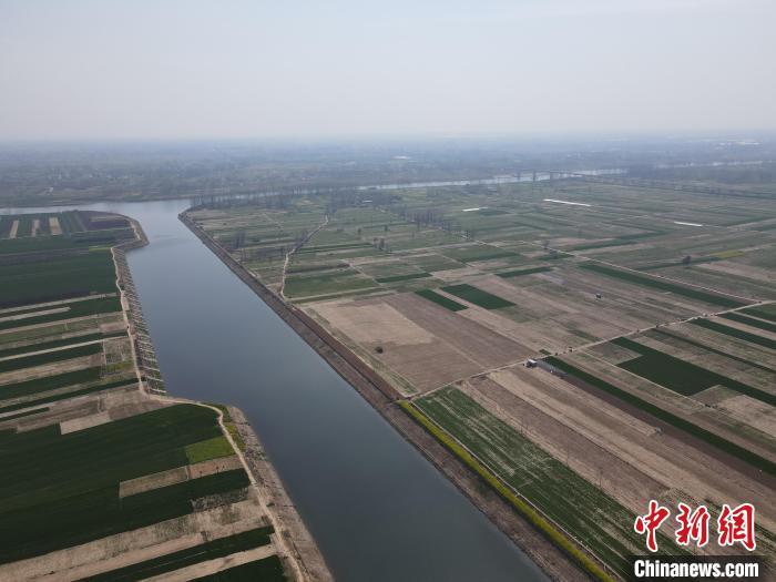 3月20日是春分节气，天气转暖，农业大省河南冬小麦开始返青起身，在位于该省南部淮滨县淮河两岸，绿油油的麦田与蜿蜒的淮河构成一幅美丽的画卷。图为淮河岸边绿油油的麦田。(无人机照片) 杨大勇 摄