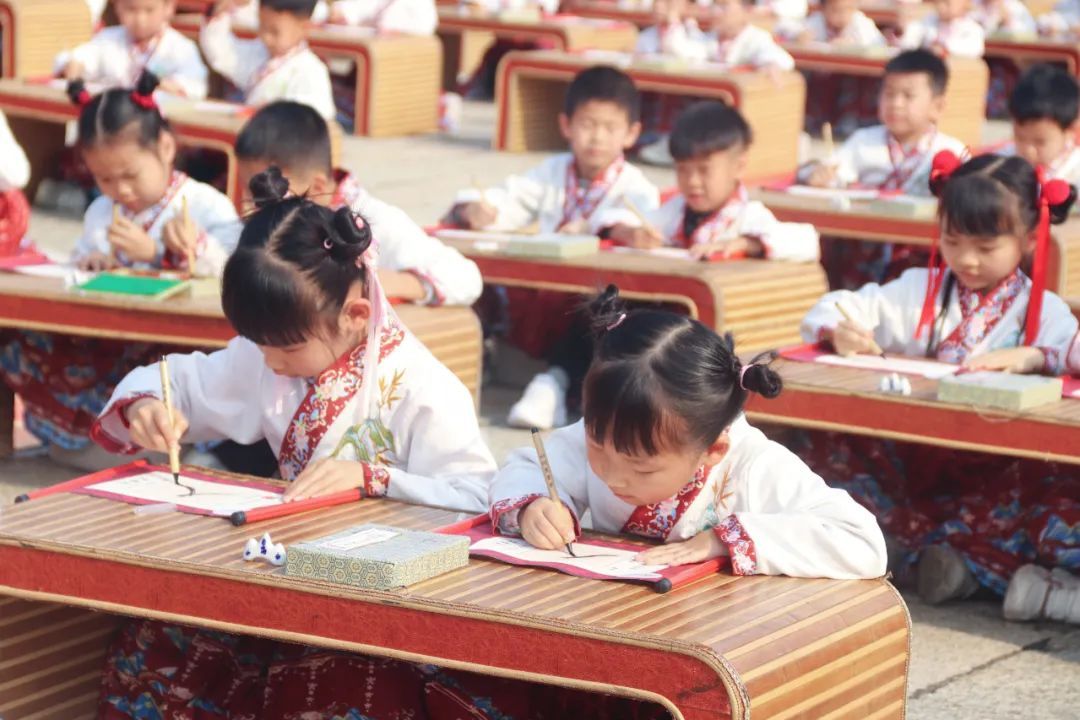 图：现场，学童们写下“人”字，感悟做学问首先要立身做人的道理