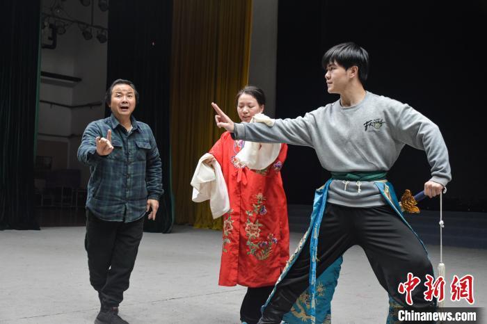 图为唐光明(图左)正在指导青年演员吴慧敏(图中)、任东(图右)排练宜黄戏《平贵别窑》。巫发阳 摄
