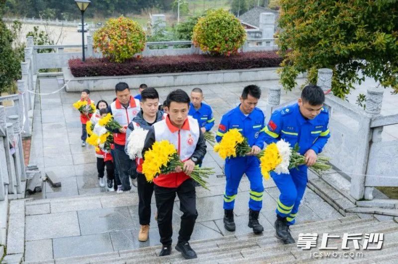 手捧菊花为烈士扫墓。