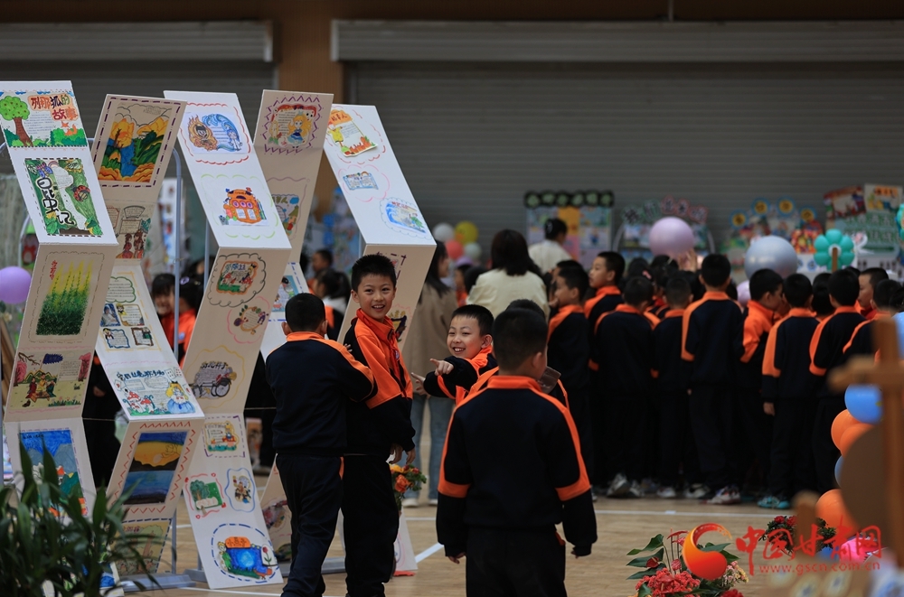 同学们在校园读书节上参观各个年级师生制作的读书笔记、手抄报,分享创作心得与体会。