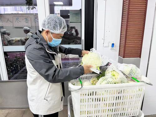 重庆市第95初级中学佳兆业校区，食品安全员吴智强正在验收蔬菜。受访者供图