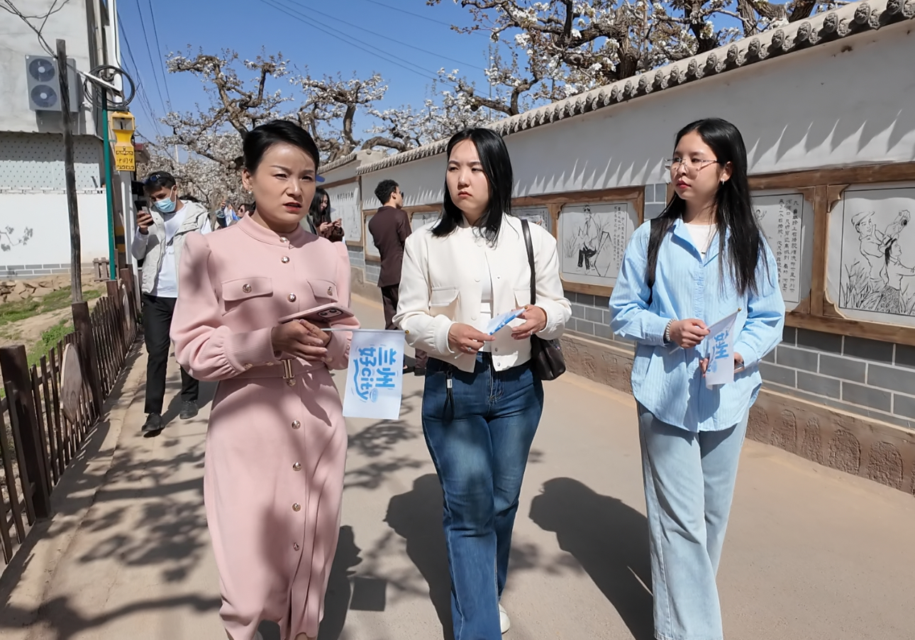 导游向外籍留学生介绍什川梨园的历史