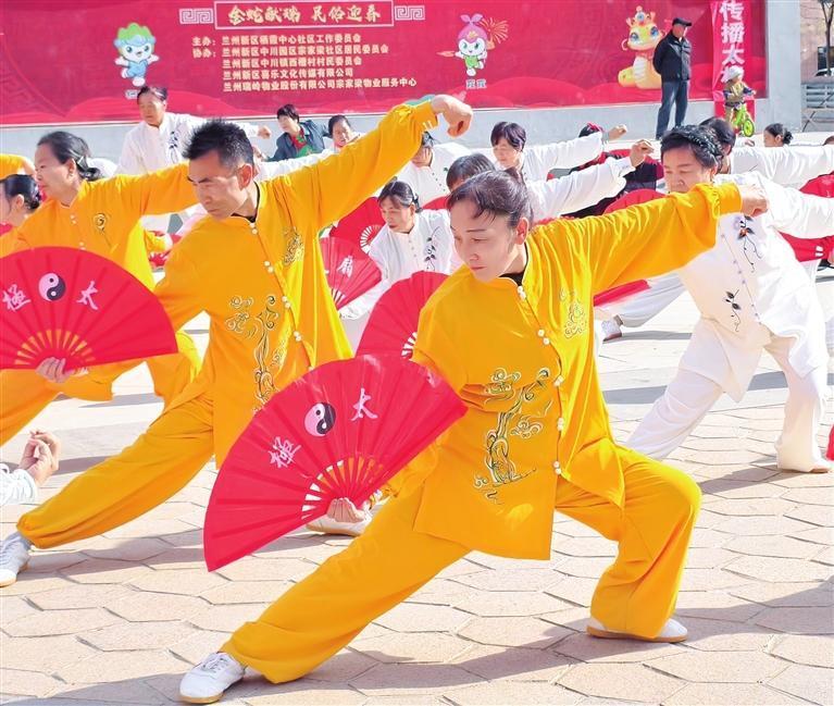 为全面提升居民健康素养，引导居民积极投身全民健身行动，4月28日，栖霞中心社区开展“太极进社区　文化润人心”太极拳展演活动。图为太极扇《中国功夫》表演。兰州新区报记者　姜波　摄