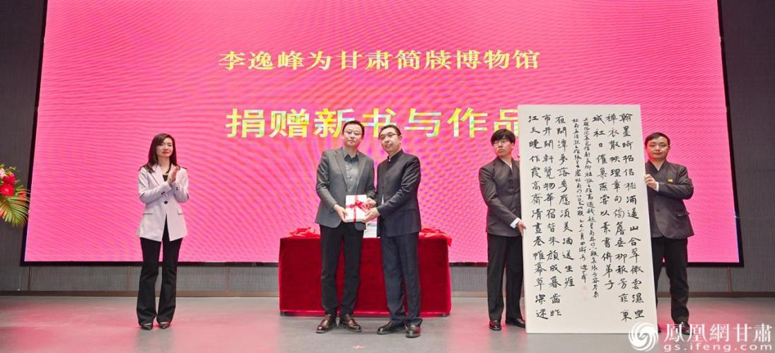 郑州大学书法学院副院长李逸峰（左三）向甘肃简牍博物馆捐赠新书与书法作品