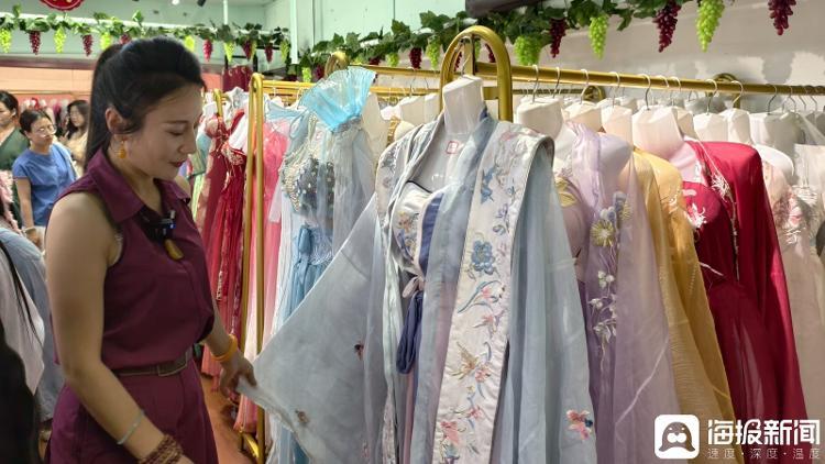 王敏正在整理店内的服装