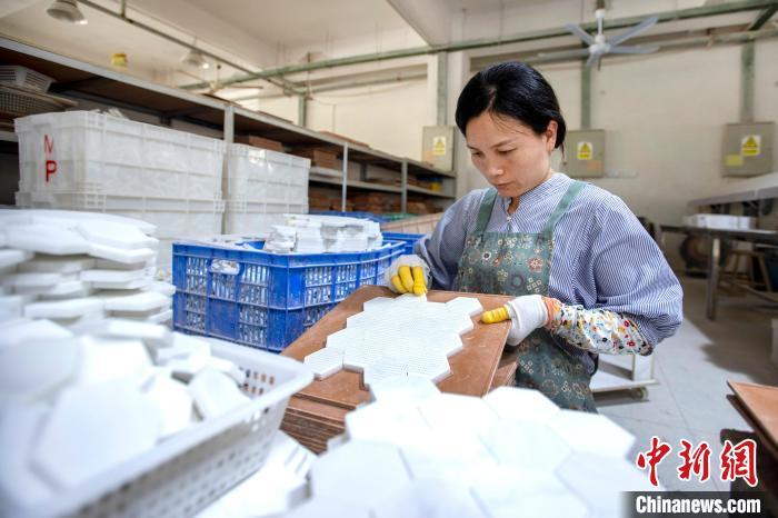 图为工人在制作贝壳装饰材料。尹志 摄