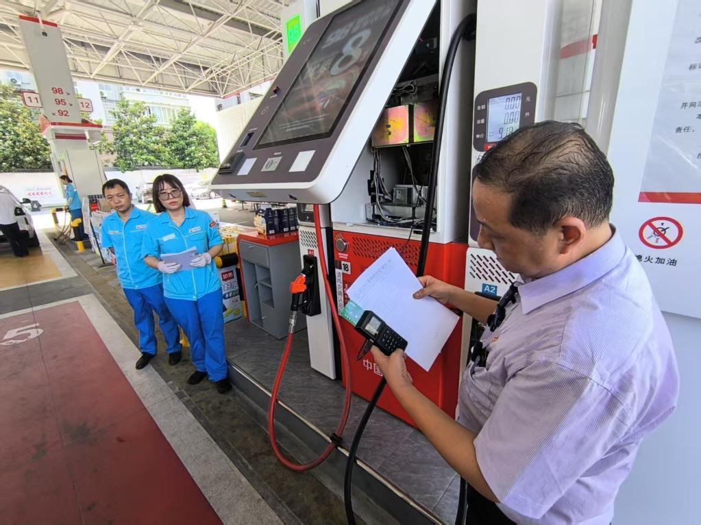 工作人员正在检查加油站设备。新华社发（陈瑶摄）