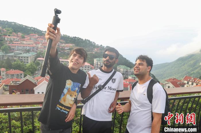5月16日,江西庐山,外籍网络达人在牯岭镇街心公园拍摄素材。中新社记者 刘力鑫 摄