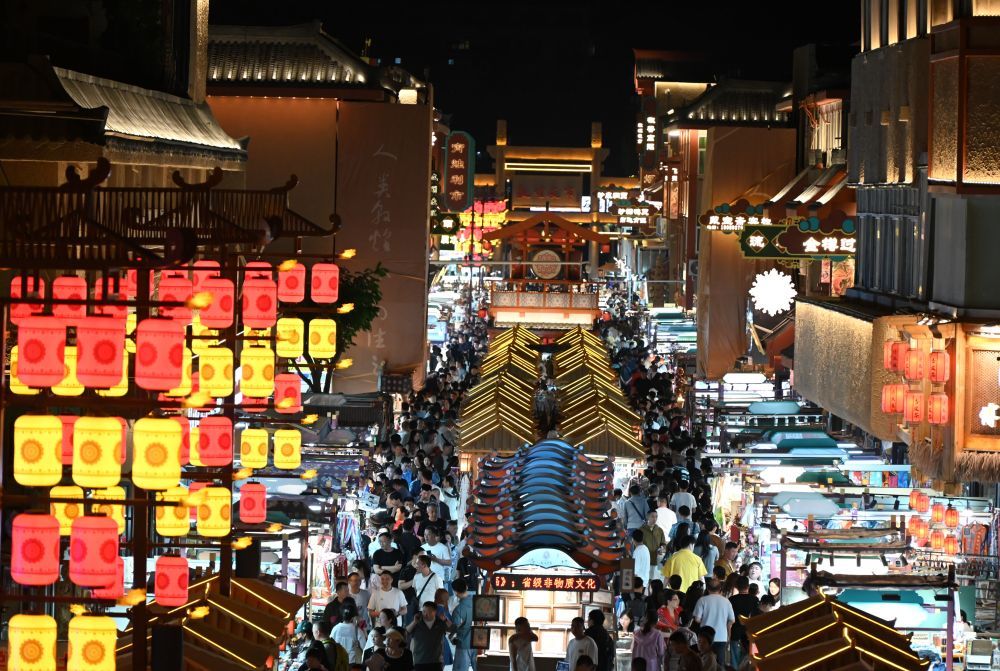 5月24日晚，游客在敦煌夜市商業(yè)街游覽。新華社發(fā)（張曉亮　攝）