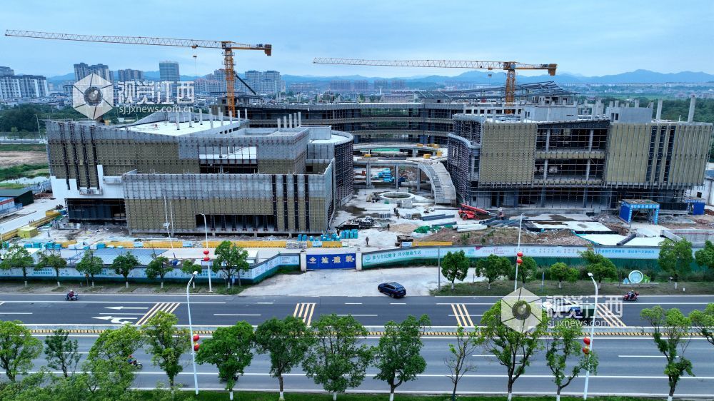 2025年6月5日,江西省遂川县文化产业中心项目施工进入竣工冲刺阶段,建筑工人正利用晴好天气抓紧幕墙等分项工程的建设。