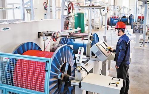 5月19日，宁晋县优唯新材料科技有限公司共享车间工人在操作设备加工线缆。