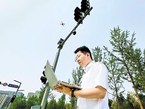 5月23日，中电信数字城市科技有限公司研发部产品经理袁云磊，在雄安新区容东片区的一条主干道旁，操作无人机进行道路巡检。本报记者 郝金钰摄