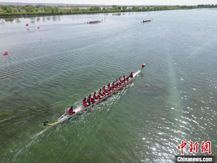 5月31日，2025年全国“我们的节日&middot;端午”主题文化活动在甘肃省张掖市高台县大湖湾崇文楼广场启幕。作为全国六个主会场之一的高台县，“龙舟竞渡庆端午”是该县连续传承近20年的一项传统文化盛会。图为湖面上龙舟参赛队劈波斩浪。（无人机图片）戴文昌 摄