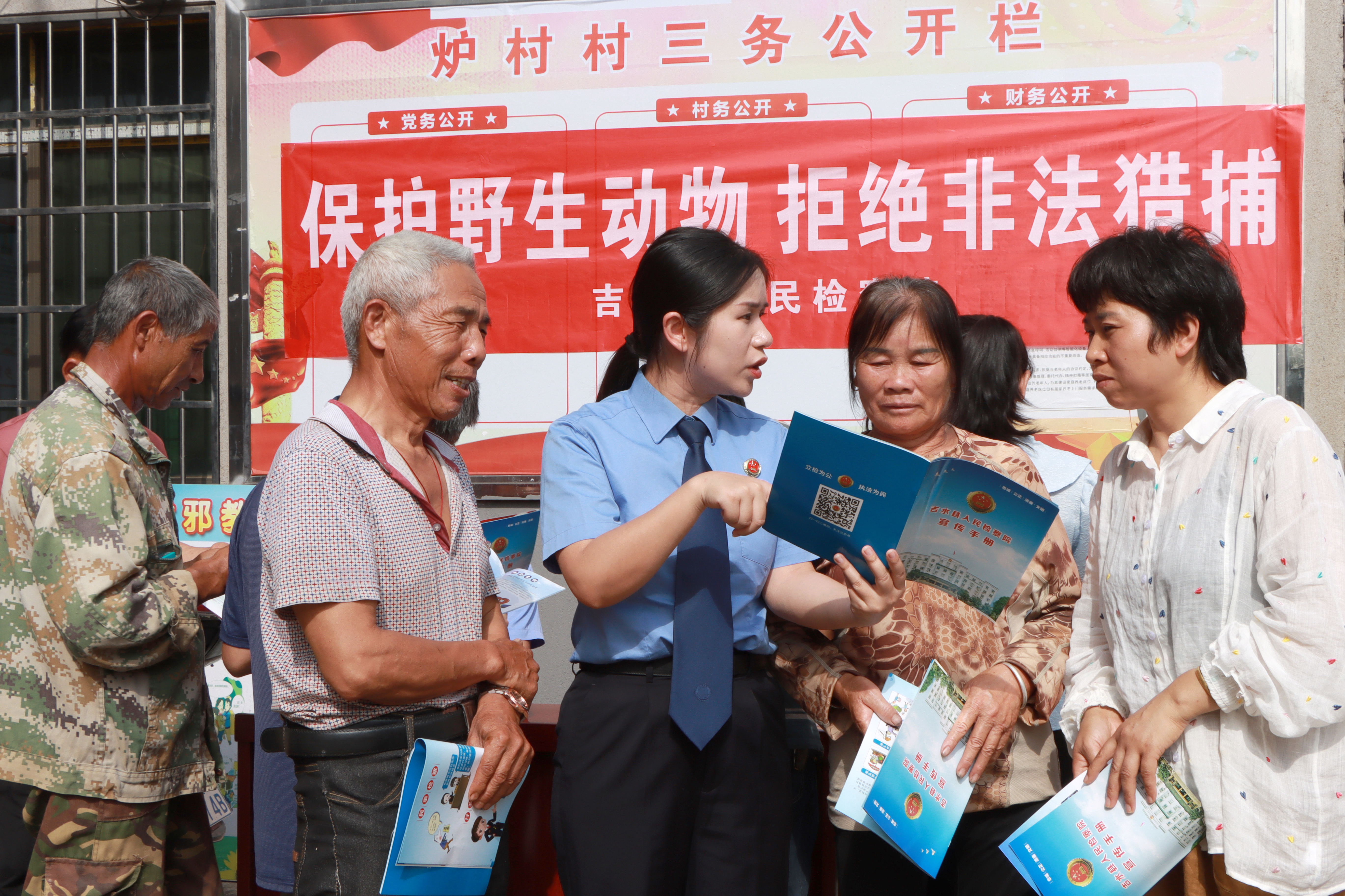 ▲检察干警向村民宣传保护野生动物、拒绝非法猎捕的法律知识。摄影丨通讯员姚卫东