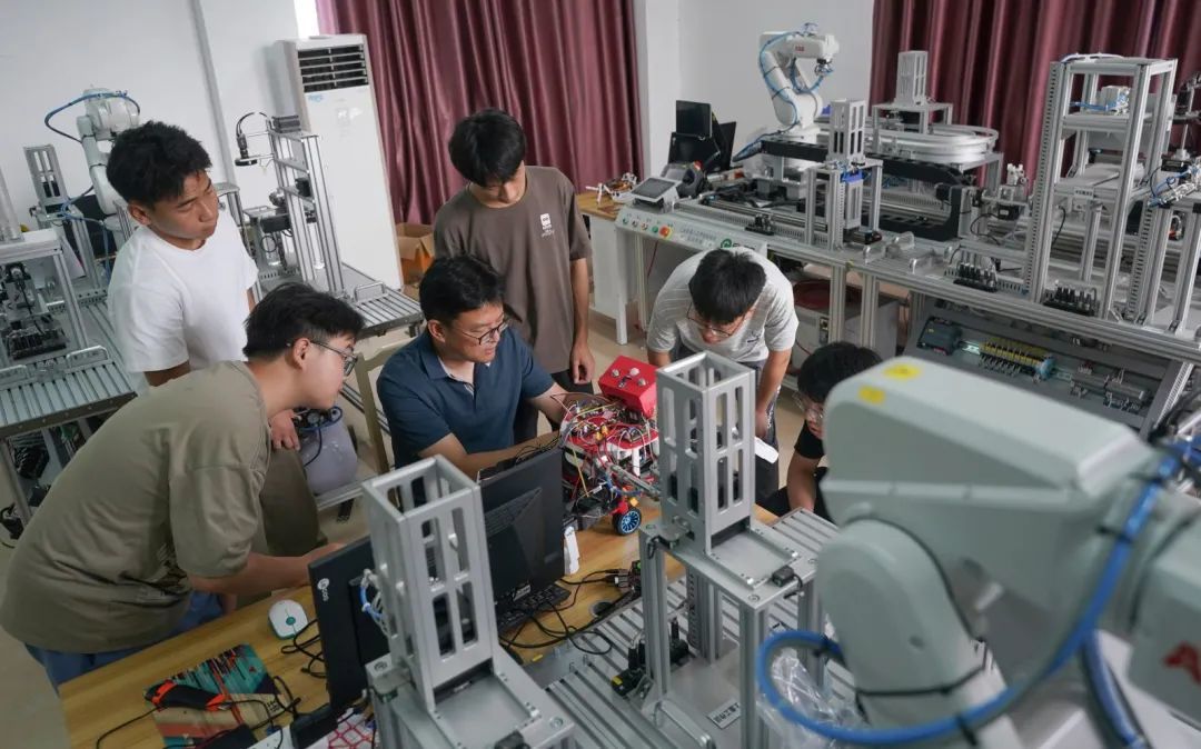 5月22日，新余學院機電工程學院博士張寶帶領大學生，在工業機器人綜合實訓基地組裝測試消防領域巡檢機器人。記者趙春亮攝