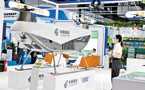 6月16日，在2025年廊坊经洽会降低全社会物流成本场景展区，观众在参观一架纵列式双旋翼无人机。本报记者 赵永辉摄