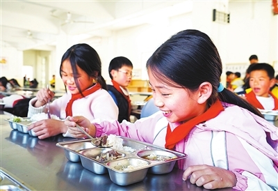 会昌县白鹅中心小学的食堂内，学生们在愉快用餐。(资料图片)