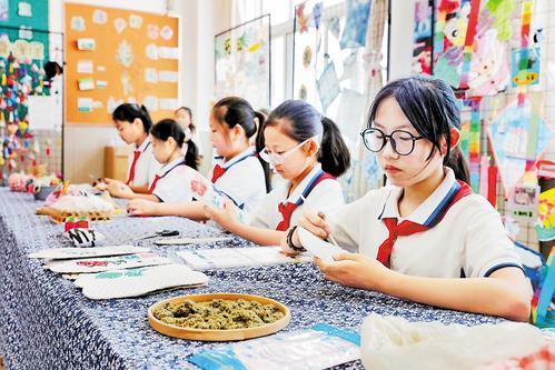 6月16日，在唐山市娘娘庙小学劳动课上，学生正在制作艾草鞋垫。 本组图片由本报记者师源摄
