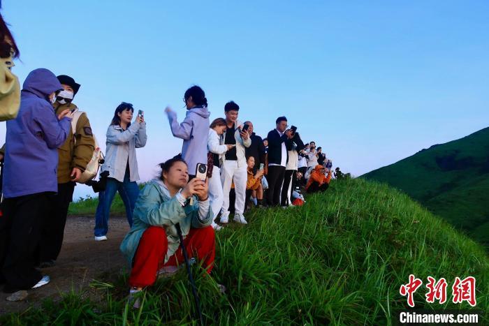 圖為7月5日，江西萍鄉(xiāng)武功山風(fēng)景名勝區(qū)，眾多游客徒步夜爬登山看日出。朱瑩 攝