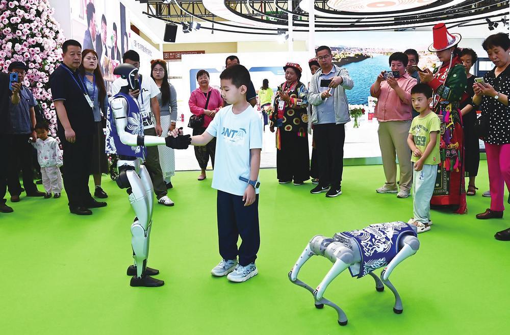 7月8日，兰洽会展馆，人形机器人与观众互动，科技感与趣味性交织，引得围观人群阵阵喝彩。新甘肃·甘肃经济日报记者　瞿娟　摄