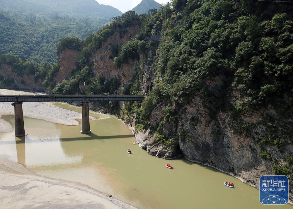 ↑游客在徽县嘉陵江上体验漂流（7月15日摄，无人机照片。）　新华社记者　马宁　摄