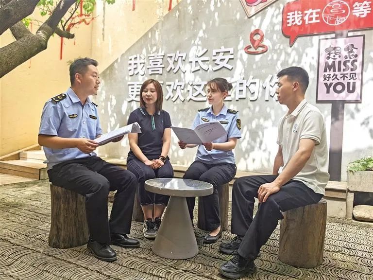 西安市长安区市场监管局工作人员为民宿负责人讲解民宿服务认证相关政策（资料照片）。