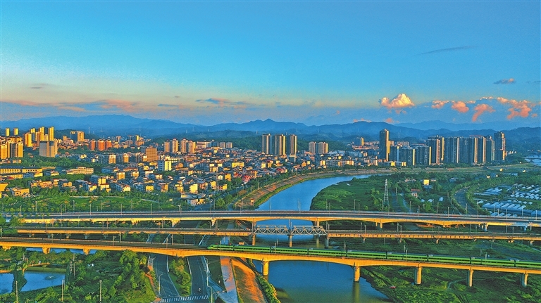 7月9日晨曦中，一列动车驶过静谧美丽的县城。特约通讯员 陈旗海摄