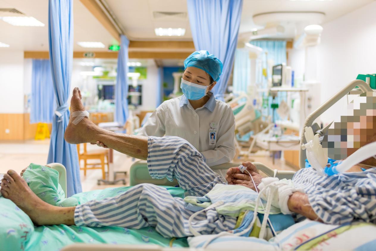 图为:医护人员为患者进行锻炼。