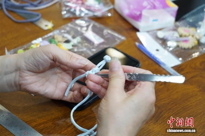 图为学员正在制作苗绣盘扣。　邓先根 摄